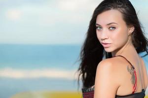 Portrait of beautiful young brunette with tattoo photo