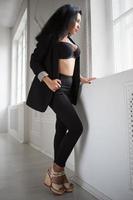 Young brunette in black clothes photo