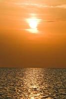 Orange sunset above a quiet serene bay photo