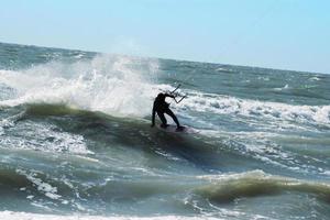 Silhouette of kite surfer photo