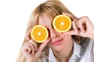 Portrait of the funny girl with oranges. Isolated on white photo