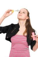 Portrait of pretty young woman blow bubbles photo