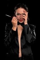 Sensual young woman with cigarette. Isolated photo