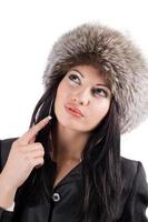 Portrait of the young woman in a fur cap. Isolated on white background photo