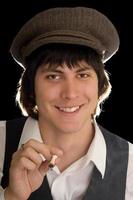 Young man smoking a cigarette in vintage clothes photo