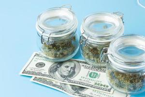 Background with marijuana buds in jars, medical cannabis use in healthcare concept. Weed business industry