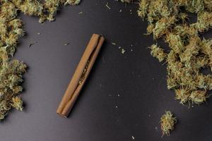 Blunt with cannabis top view on background with copy space. Marijuana medical or recreational use concept photo