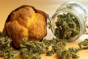 Muffin with cannabis buds. Marijuana food products. Legal THC medicinal or recreational use photo