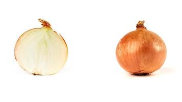 half and a whole round onion in brown husk on a white background photo