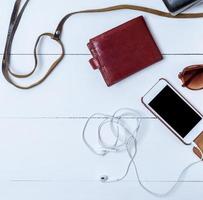 smartphone with a blank black screen, brown leather wallet photo