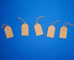 set of empty paper brown rectangular tags on a rope, price tags photo