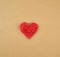 red wicker decorative heart on a brown paper photo