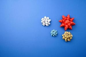 knotted multi-colored ribbon bows on a blue background photo