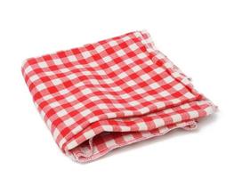 folded cotton red white checkered napkin on a white background photo