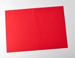 torn in half empty red sheet of paper on white background photo