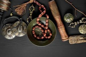 Copper singing bowl, prayer beads, prayer drum photo