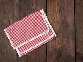 white red checkered kitchen towel on a brown wooden background photo