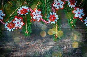 Christmas gray wooden background with colored bokeh and decorated with fir branch photo