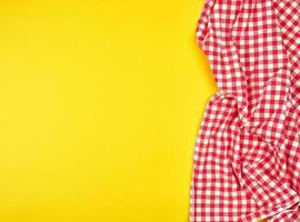 red kitchen towel in a cage on a yellow background photo