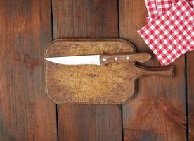 very old empty wooden rectangular cutting board and knife photo