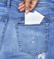 female hand puts an empty white paper card photo