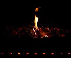 Smoldering coals and fire on a black background photo