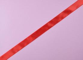 red satin ribbon on a purple  background photo