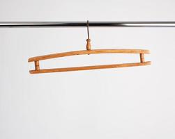 vintage wooden hanger hanging on a metal pipe photo