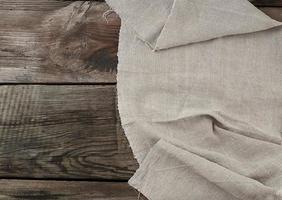 Gray linen napkin kitchen wooden background in vintage style photo