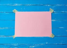 glued with adhesive tape a rectangular empty pink sheet of paper photo