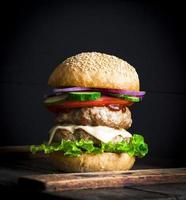 large burger with two fried cutlets photo