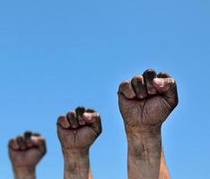 Three dirty male fists raised up photo