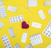 red heart and catheter on a yellow background photo