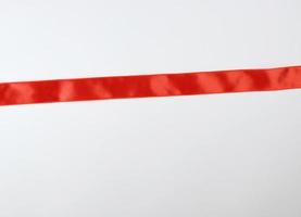 red satin ribbon on white background photo