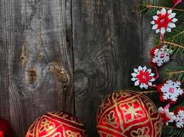 Christmas background with decorated branches of spruce and red glass balls photo