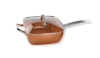 copper deep frying pan with transparent lid on white background photo