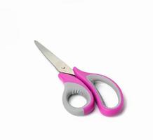 metal scissors with pink plastic handle for paper isolated on white background photo