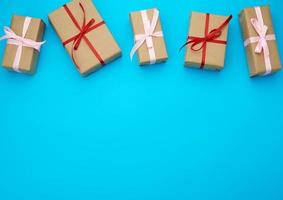 boxes wrapped in brown paper and tied with a red bow photo