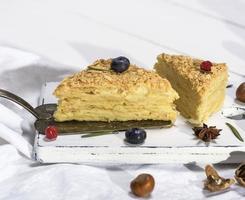 two baked cakes Napoleon with cream photo