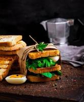 sandwich of French toast and lettuce leaves and boiled egg photo