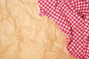 white red checkered kitchen towel on a brown paper background photo