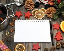 notebook and black pencil and pan with mulled wine photo