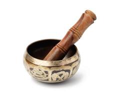 copper singing bowl and wooden mallet isolated on white background. Musical instrument for meditation, relaxation photo