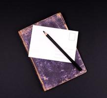 blank white paper card and black wooden pencil photo