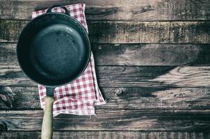 Empty frying pan on a textile napkin photo