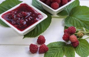 Ripe red raspberries and raspberry jam photo