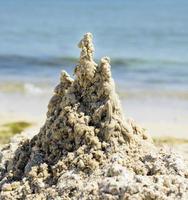 sand castle on the beach on a summer sunny day photo