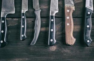 various knives on a brown wooden board photo
