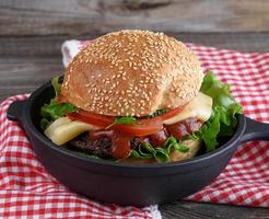 burger with a meatball and vegetables photo