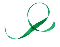 green silk ribbon in the shape of a loop isolated on white background photo